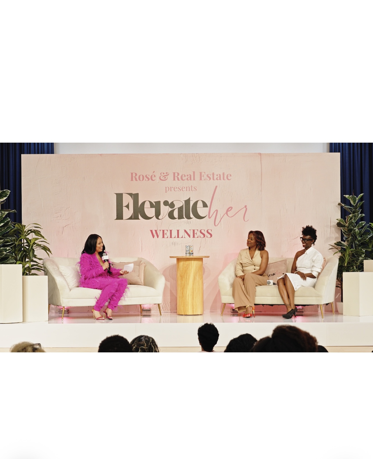 Zena Dixon leading a wellness conversation with two panelists at the ElevateHER Convention